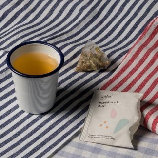 Simple cup of herbal organic infusion with line-pattern fabrics
